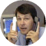 Tom talking on two phones at once